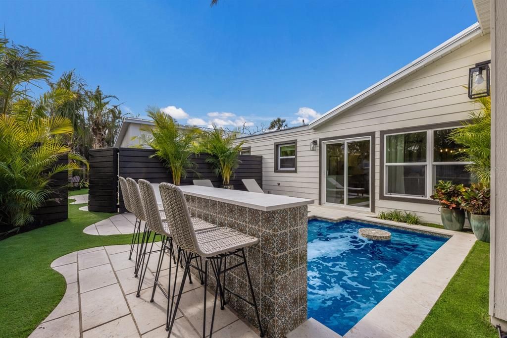 Outdoor bar seating overlooking the heated private pool - East side