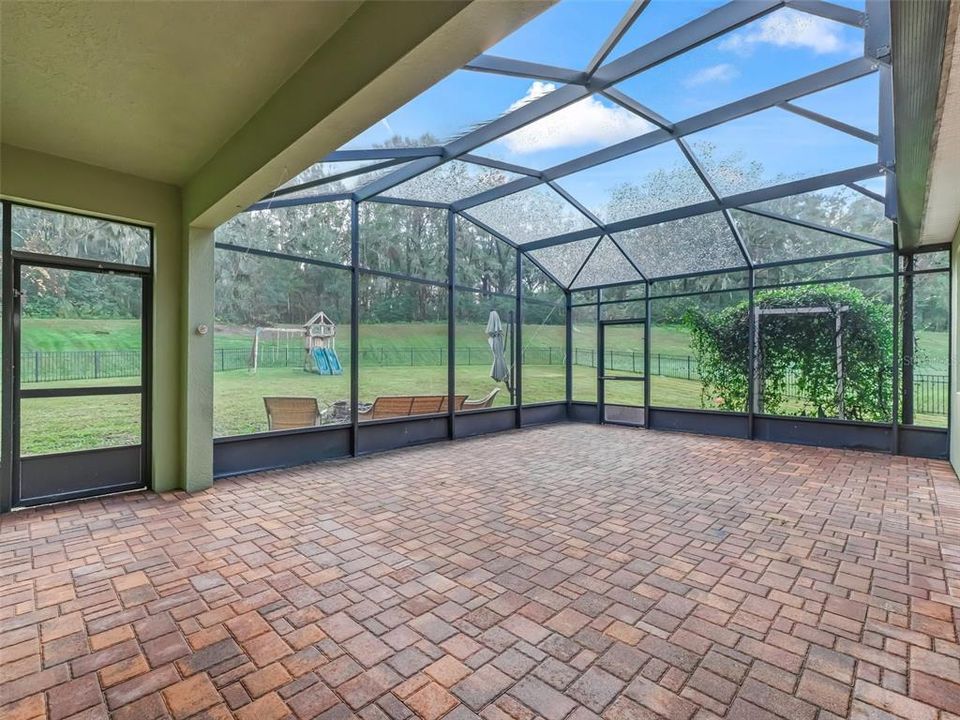 NEWLY SCREENED PORCH WITH PAVERS