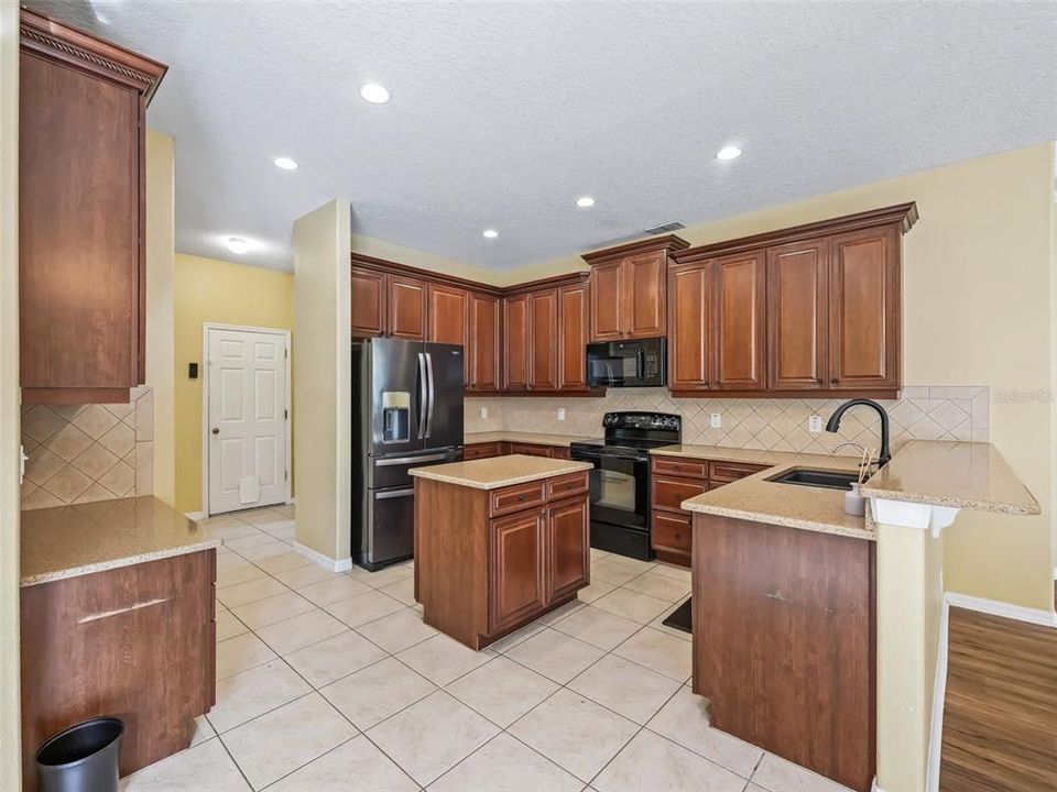 LARGE OPEN KITCHEN WITH ISLAND 42" CABINETS AND GRANITE