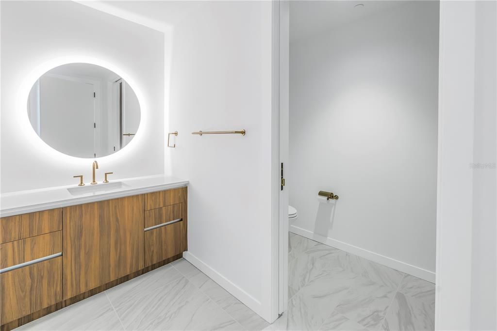 Primary bathroom with backlit mirror