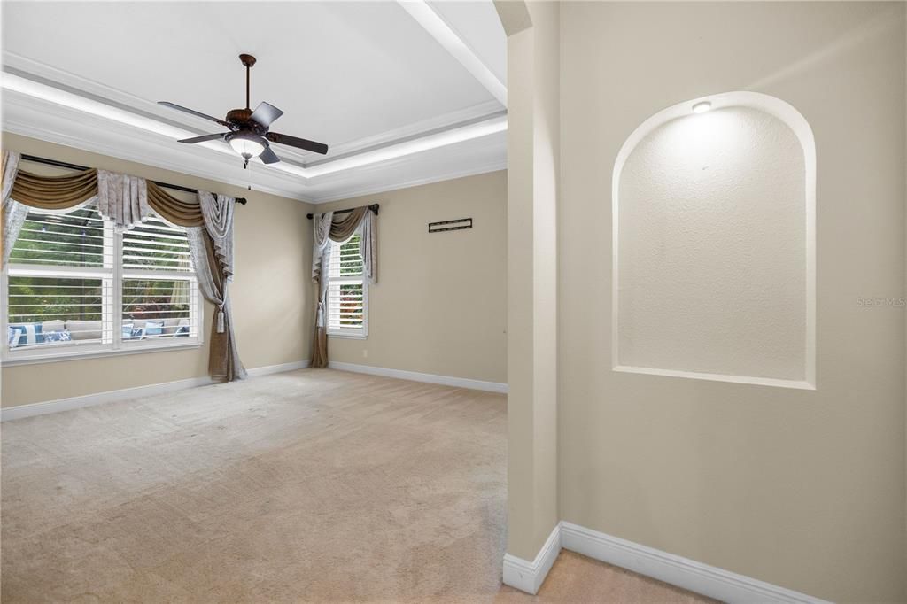 Primary suite entrance with built-in shelving and lighting