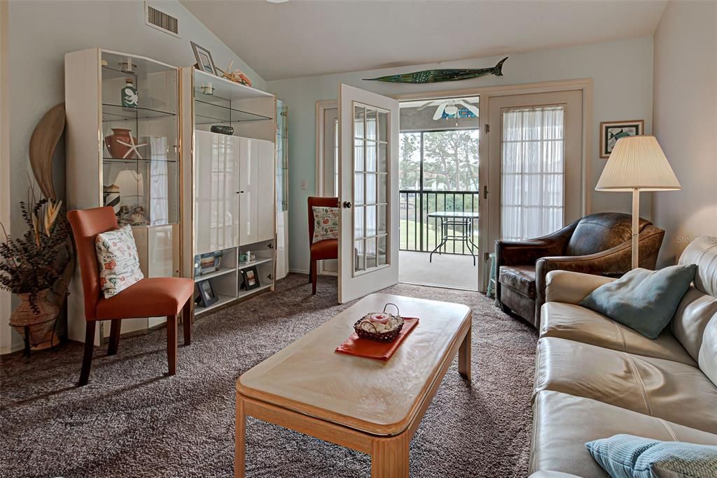 Doors open onto the screened balcony with lake view.