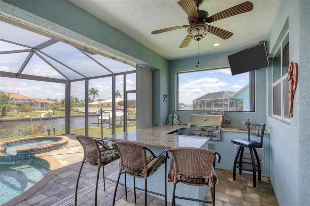 Summer Kitchen with Granite Bar, Sink, Grill, Mini Fridge, and Ice Maker