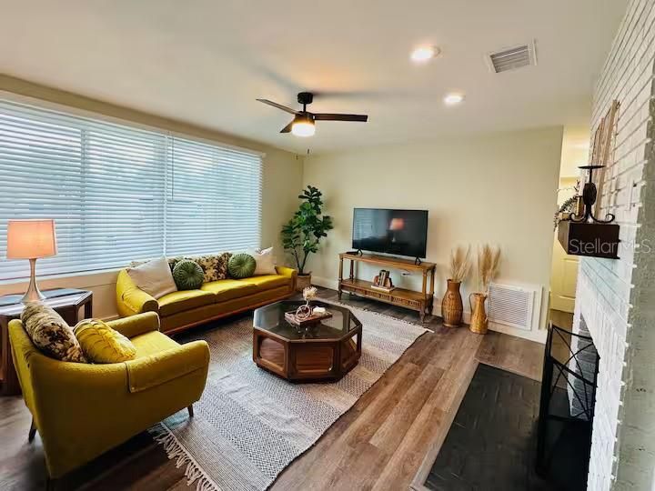 Living room with a ceiling fan.