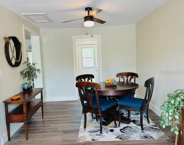 Spacious dining room with a ceiling fan.