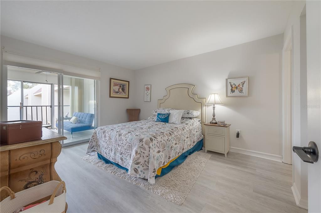 Primary Bedroom with Sliders and Blinds open for views.