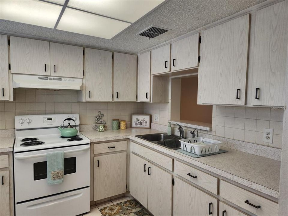 Kitchen has tons of cabinets and counter space.