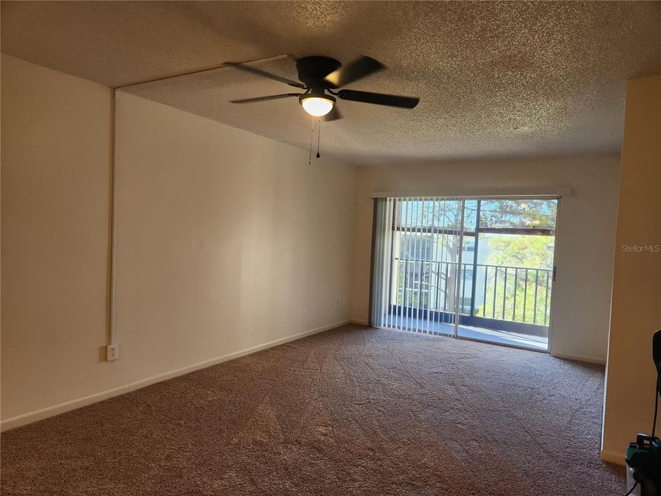 Living room has sliding doors out to screened porch overlooking the tree tops.