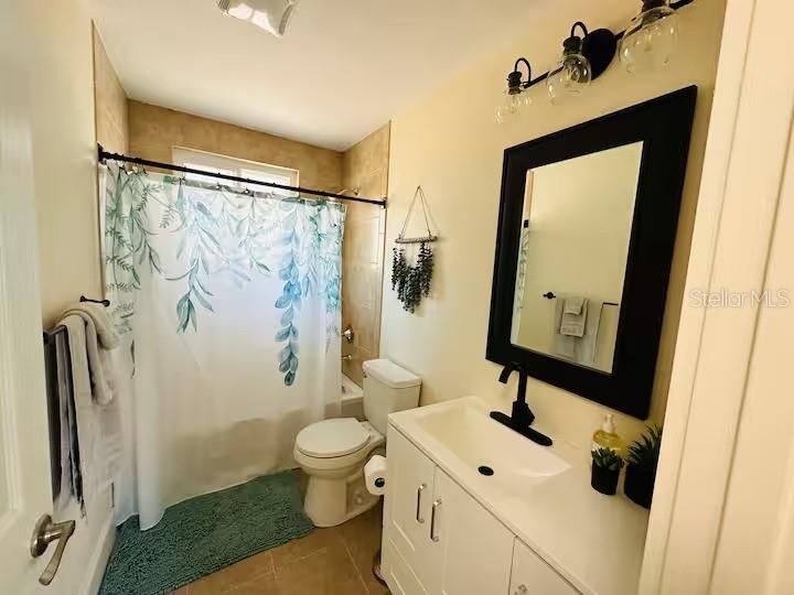 Bathroom in the bigger unit with a tub shower.