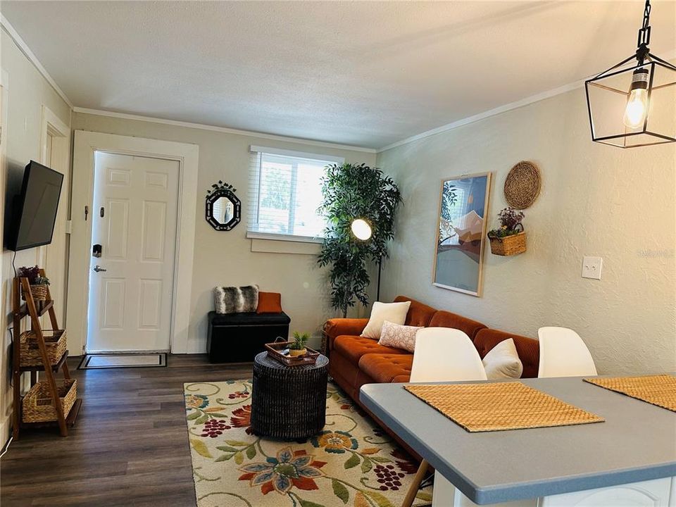 Overview of the living-dining room area in the smaller unit.