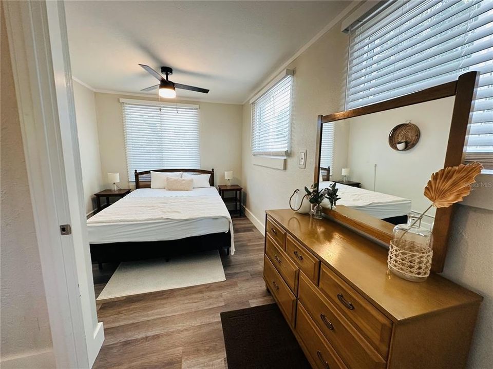 Bedroom in the smaller unit with a ceiling fan.