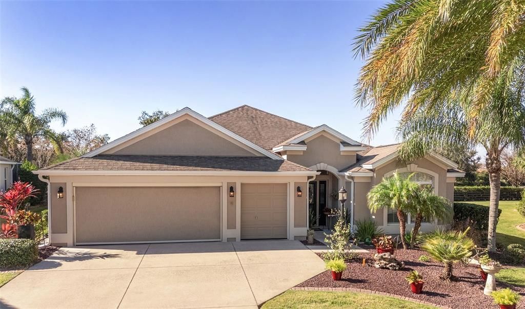 FRONT EXTERIOR - Lovely IRIS Designer w/ 3 BR/ 2BA/ 2.5 Car Garage, CBS exterior, REAR PRIVACY with NO HOMES BEHIND, ROOM for a POOL, and the exceptional VILLAGES LIFESTYLE.