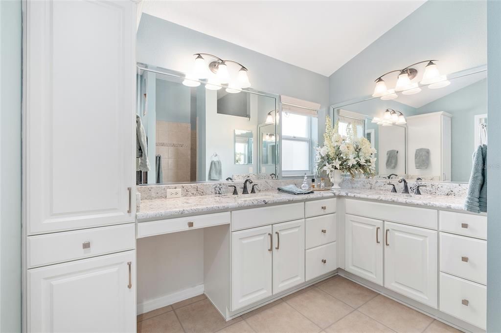 ENSUITE BATHROOM features matching GRANITE COUNTERTOPS, dual sinks/vanities, and updated hardware. ROMAN SHOWER is visible in mirror on L.