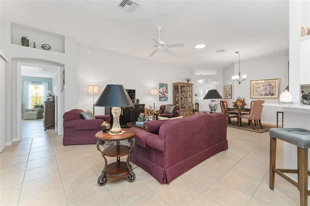 View of LIVING ROOM - Shows decorative arch over doorway to PRIMARY BEDROOM.