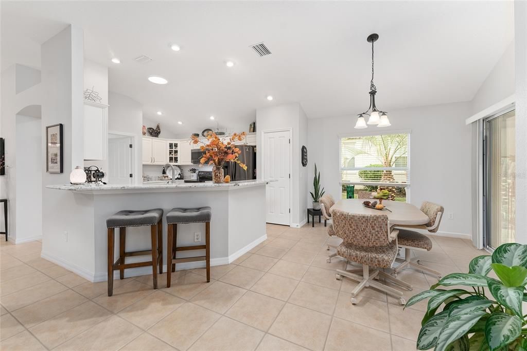 View of KITCHEN and BREAKFAST NOOK - Shows SLIDING GLASS DOORS to ENCLOSED LANAI on R.