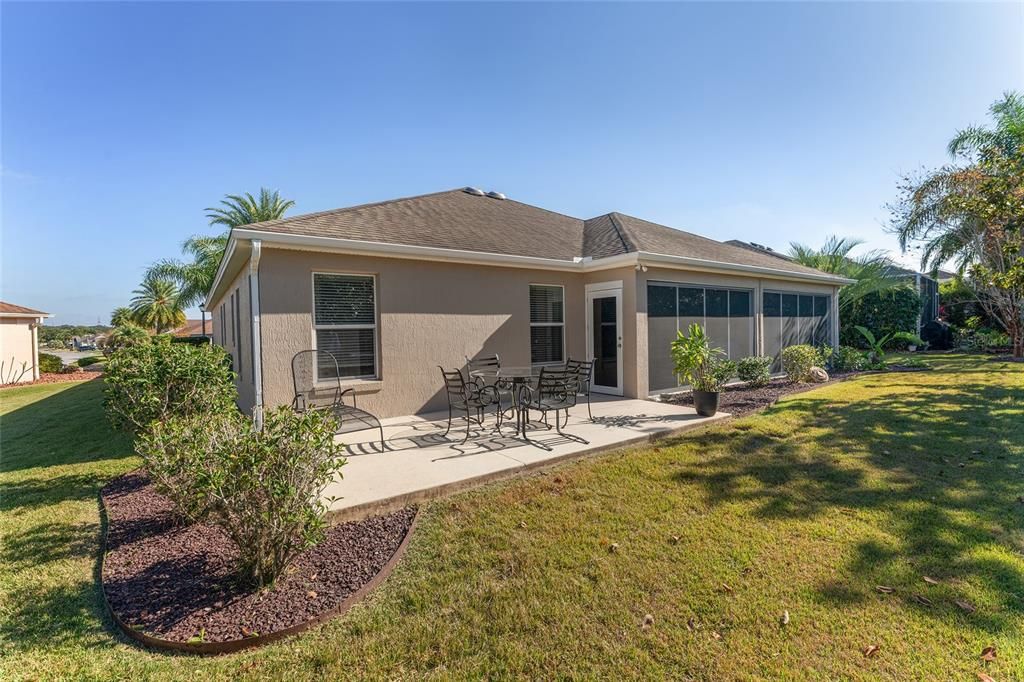 REAR EXTERIOR - Note oversized OPEN PATIO located off of ENCLOSED LANAI.