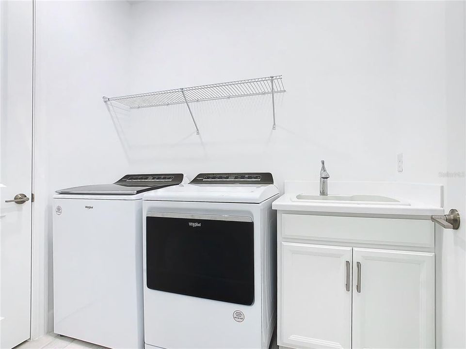 Laundry Room with drop in sink and cabinetry.