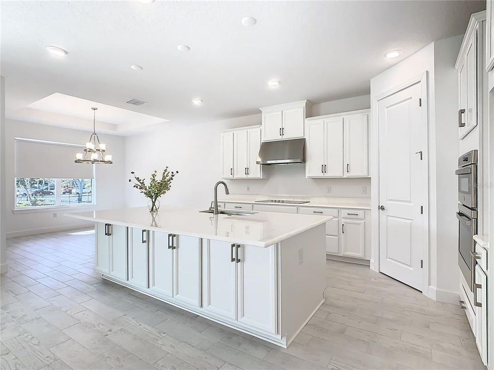 Varigated Kitchen cabinets with brushed nickel handles.