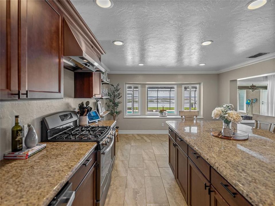 Kitchen window overlooks pool area and lake