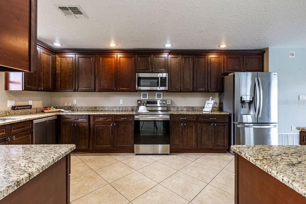 Huge Kitchen with newer stainless steal appliances, cherry cabinetry and granite!