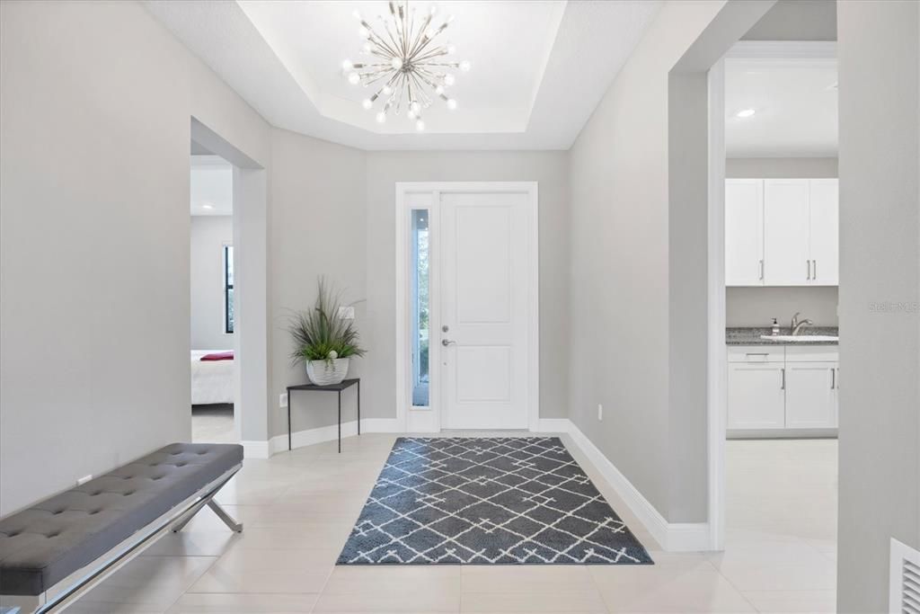 Foyer with designer lighting and upgraded tiling throughout