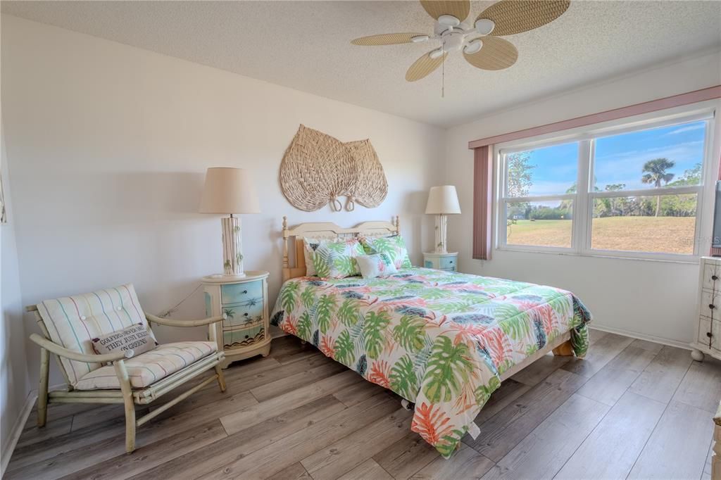 The Primary bedroom features wood laminate flooring,  neutral tones, a ceiling fan and has an ensuite bath.