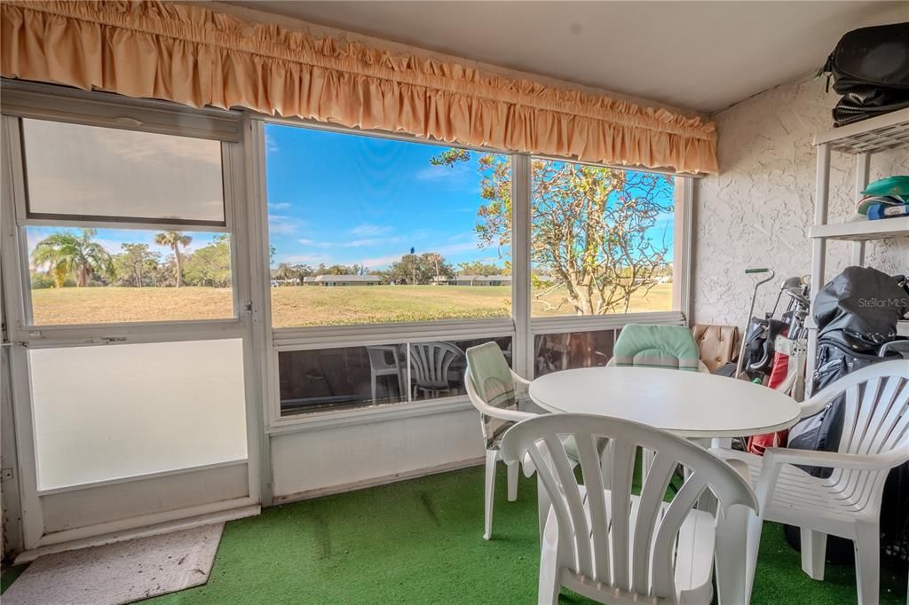 The screened in lanai has an unobstructed view of the green.