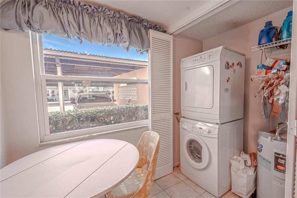 A convenient laundry closet in the kitchen with a stackable washer/dryer.