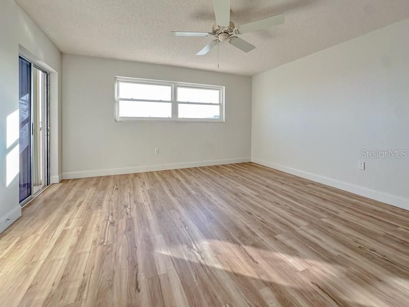 primary bedroom with sliding door to lanai