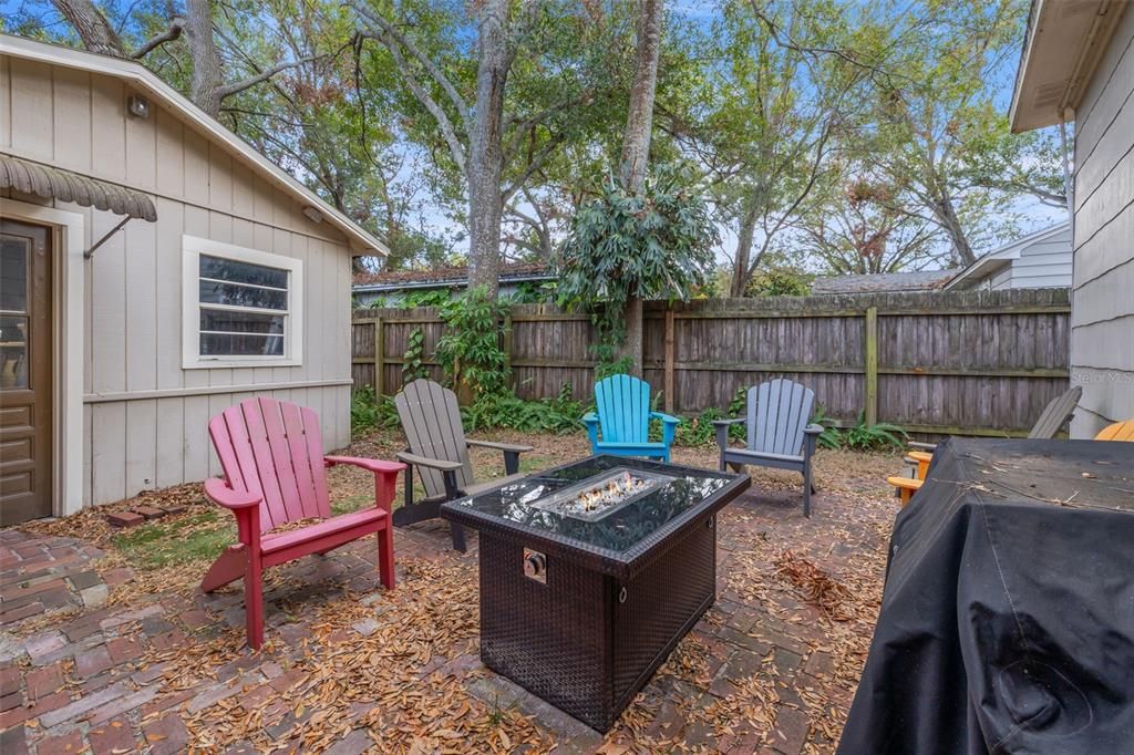 Fenced back yard with fire pit