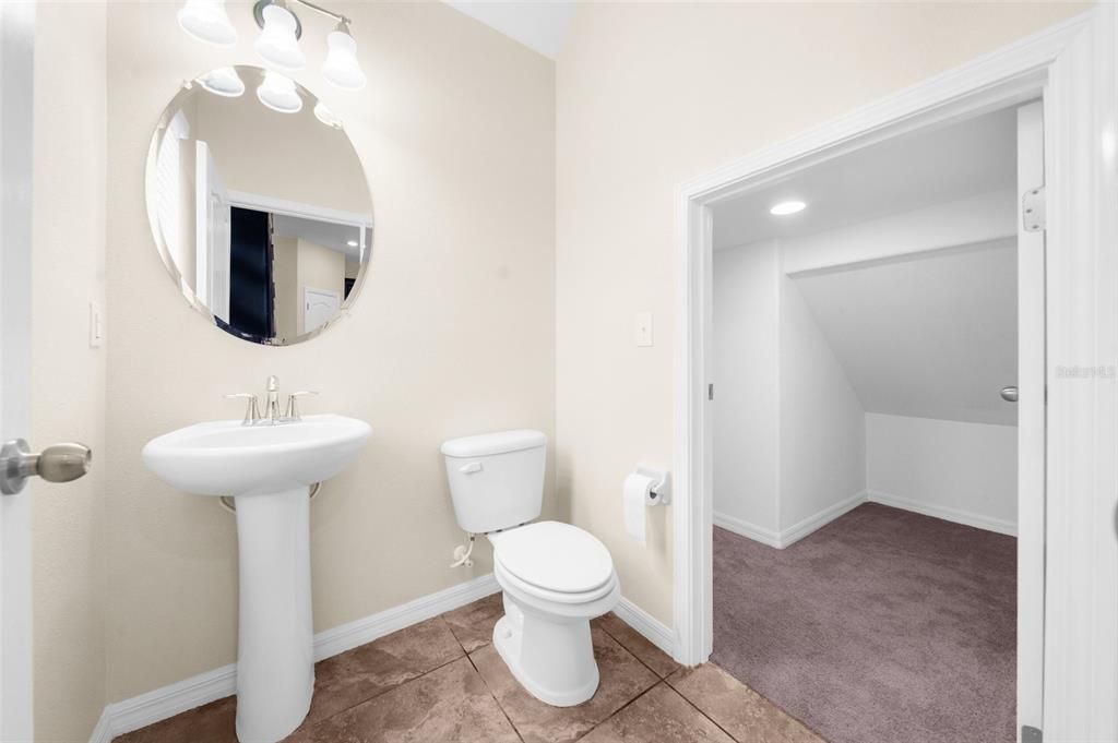 Downstairs half bath with access to large storag