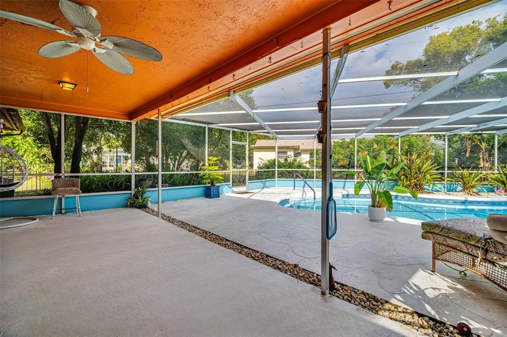 Pool deck offers large covered area for lounging and entertaining~