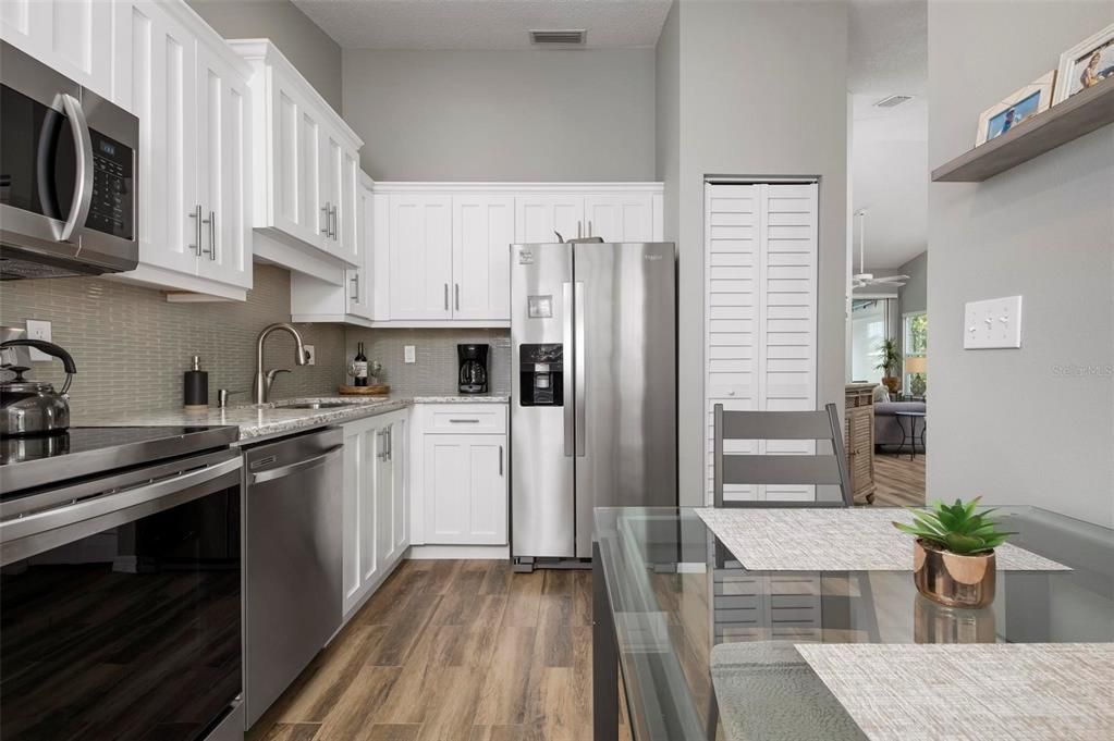 Kitchen with stainless appliances and shaker style cabinetry