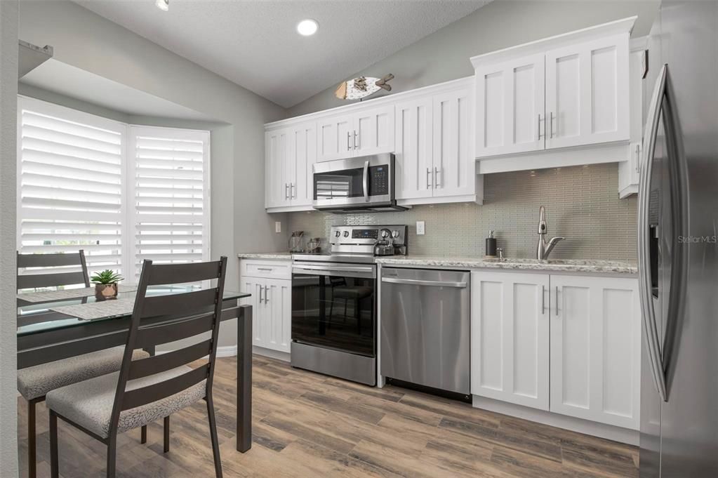 Kitchen with stainless appliances and shaker style cabinetry