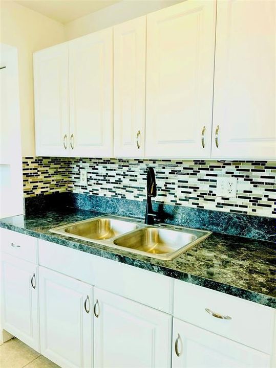 White cabinets and stainless sink