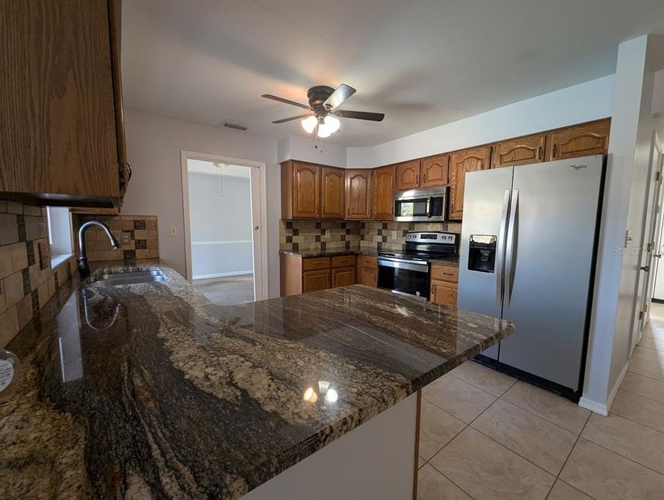 Kitchen with updated appliances, granite counters and stainless appliances