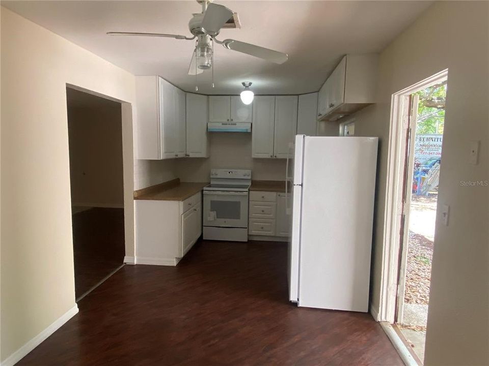 kitchen from dining area. 3rd bedroom to your left. Door to back yard with utility room, to your right.