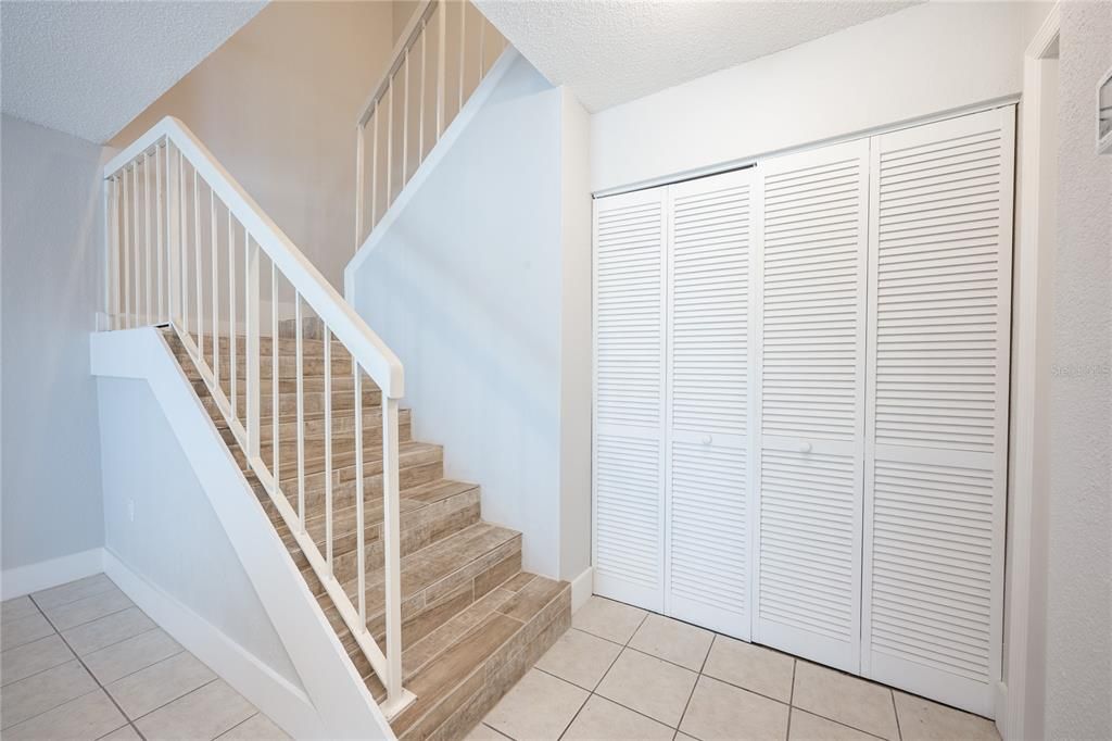 Staircase features the wood look tile floors found throughout the second floor.