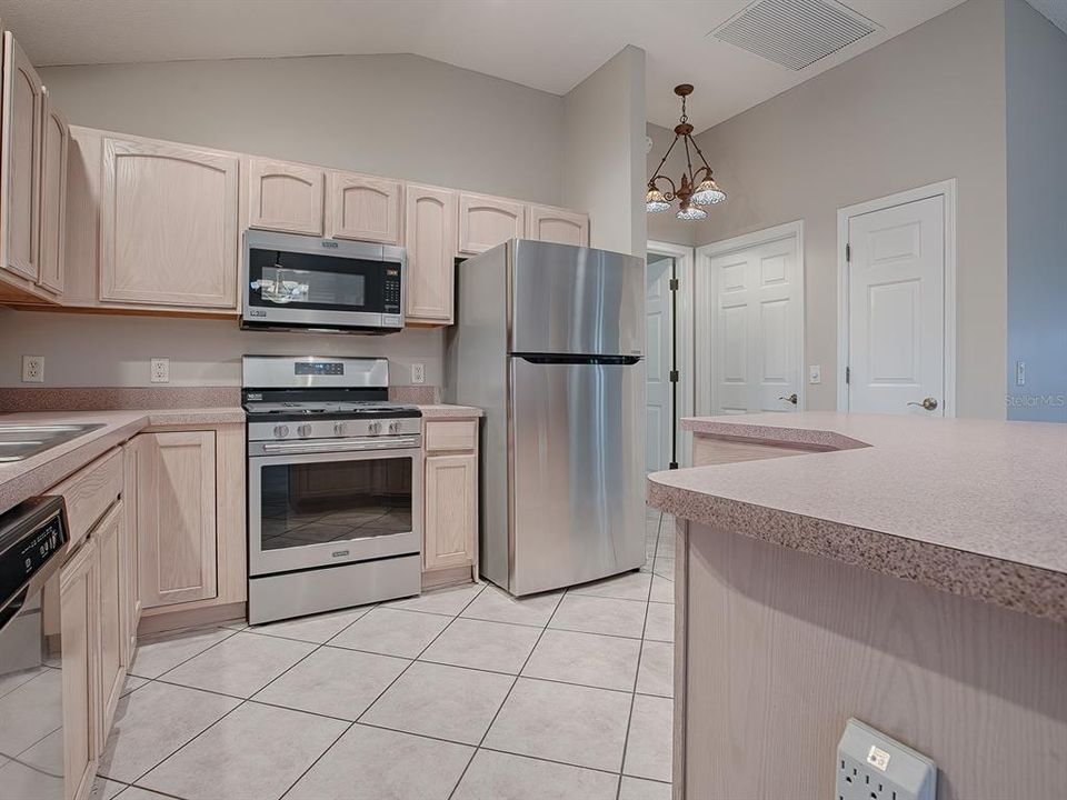 KITCHEN FEATURES STAINLESS APPLIANCES INCLUDING GAS RANGE