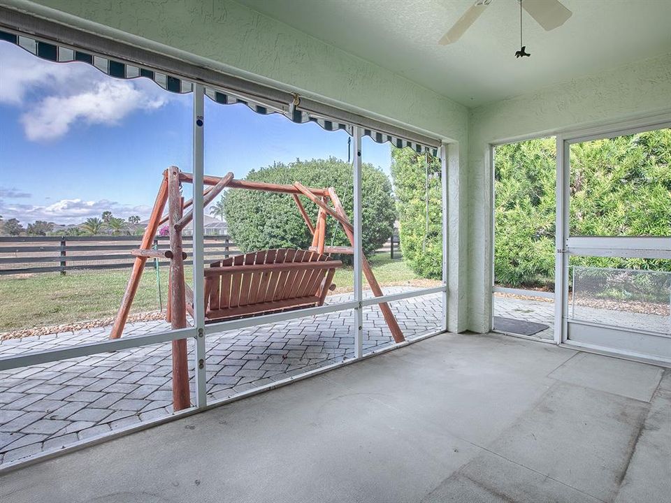 SCREENED LANAI LOOKING OUT ONTO PAVER PATIO