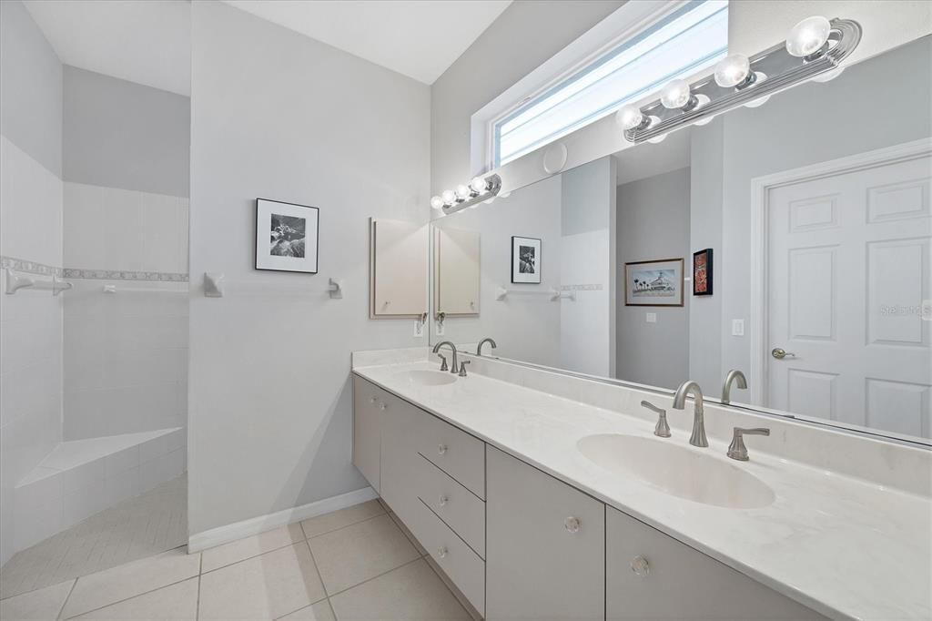 Primary ensuite bathroom, with double vanities, large walk-in shower, a separate toilet stall and large walk in closet