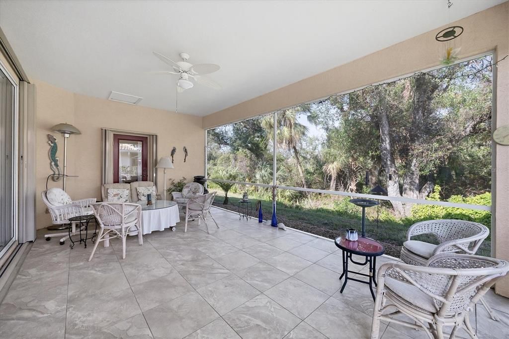 Large screened in lanai with lots of room to lounge and sit. Privacy abounds with a view of tropical foliage