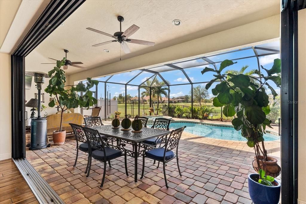 Sliding Glass Doors Lead Directly to Serene Outdoor Seating by the Pool