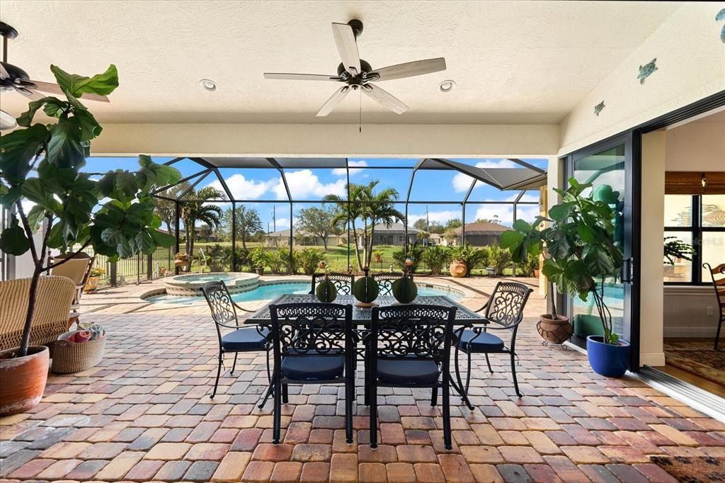 Sliding Glass Doors Lead Directly to Serene Outdoor Seating by the Pool