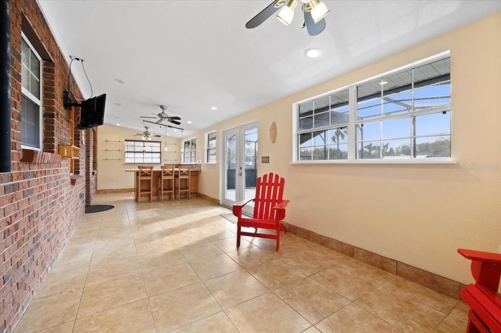 florida room with built in bar with fridge and ice maker