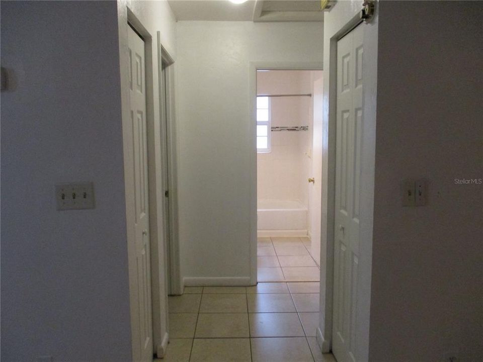 Hallway access to bedrooms with two closets