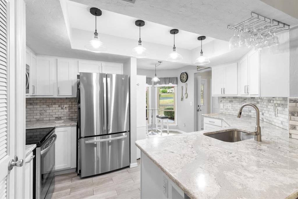 Updated Kitchen with White Shaker Cabinets, Quartz Countertops, Stainless Steel Appliances, Tray Ceiling, Pantry Closet, Breakfast Bar & Breakfast Nook