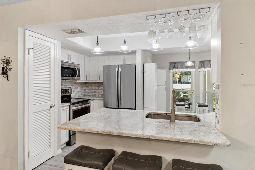 Updated Kitchen with White Shaker Cabinets, Quartz Countertops, Stainless Steel Appliances, Tray Ceiling, Pantry Closet, Breakfast Bar & Breakfast Nook