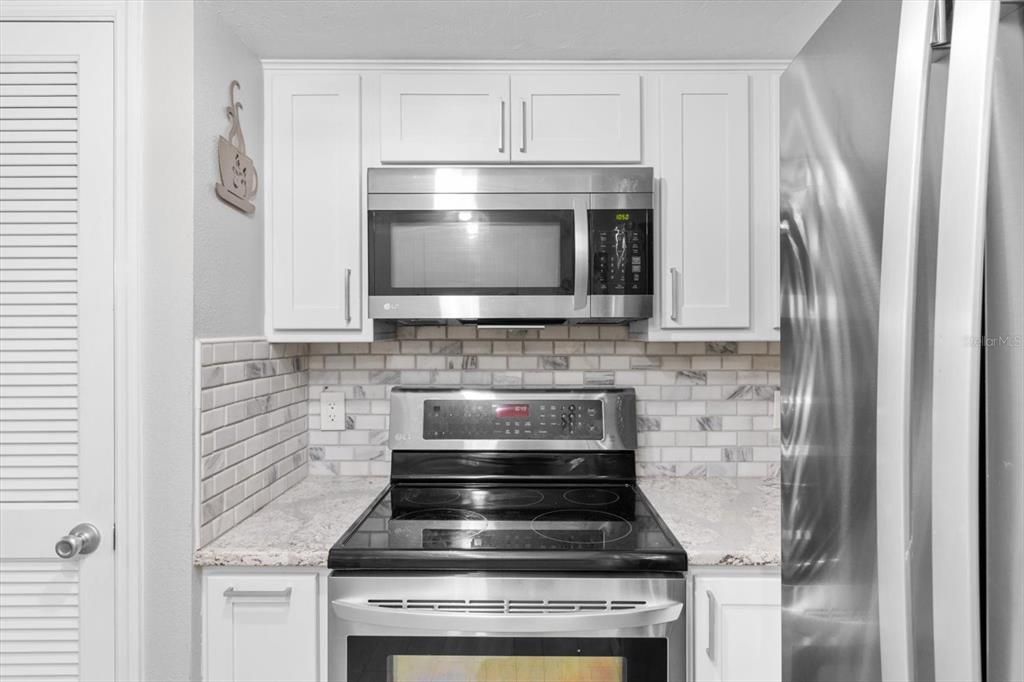 Microwave over Electric Range..Pantry Closet on Left