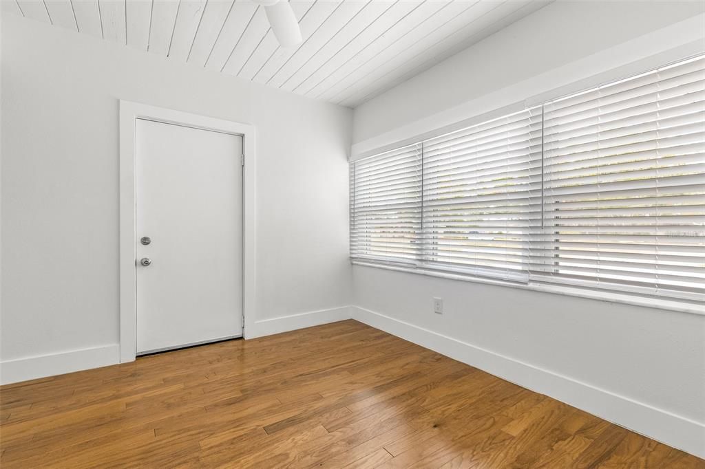 Bead board ceiling in office/den; door opens to garage